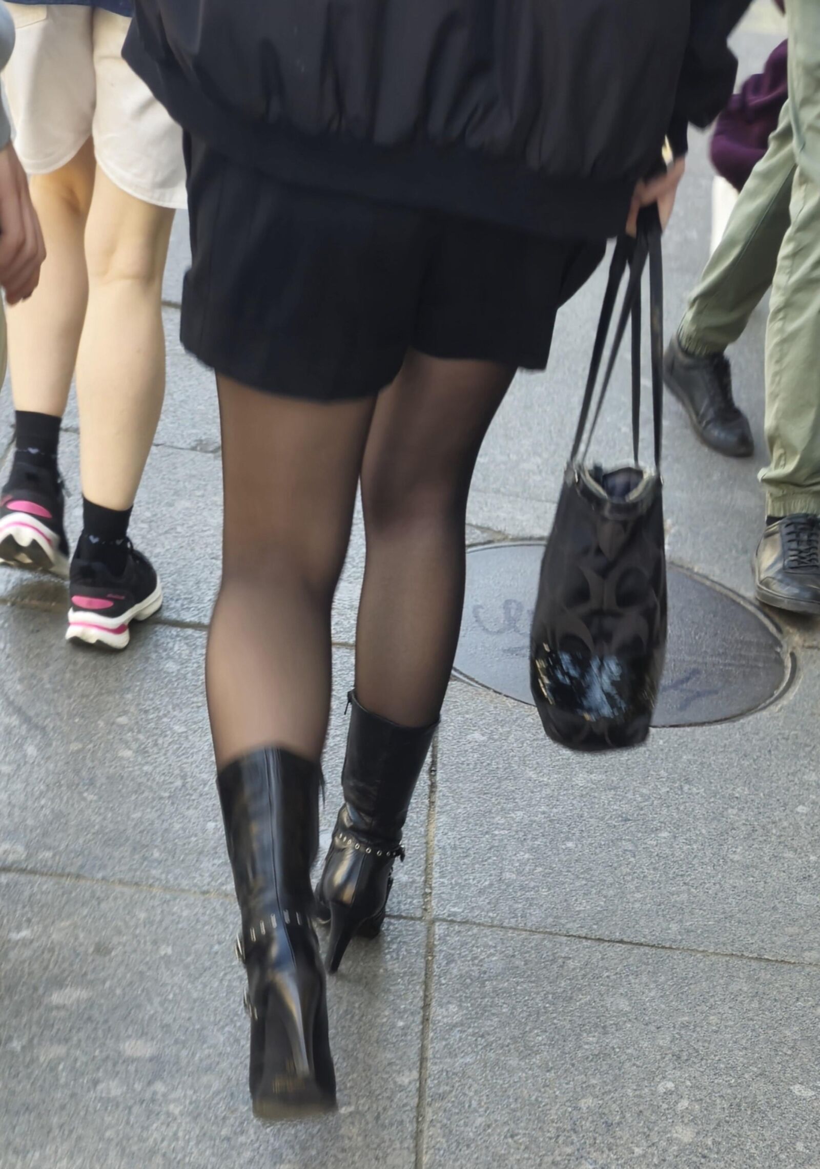 Girl in black pantyhose and leather boots