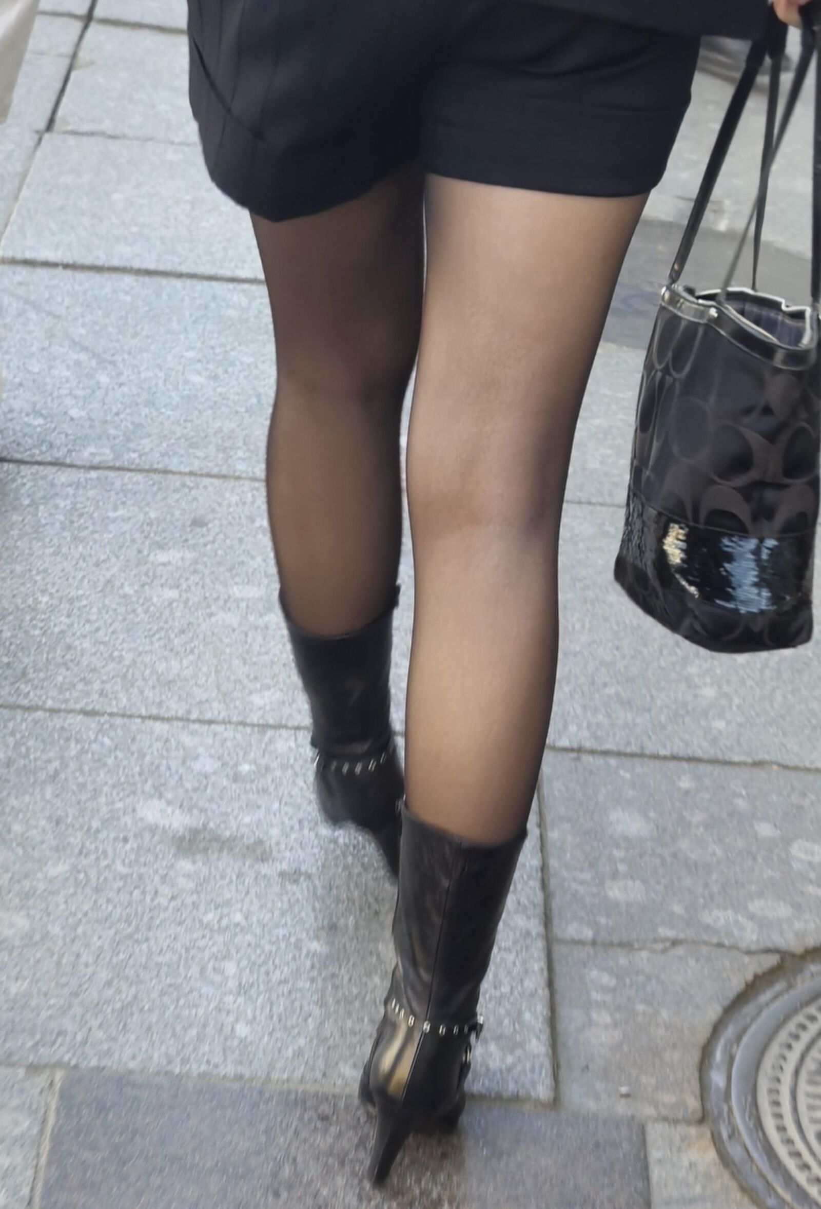 Girl in black pantyhose and leather boots