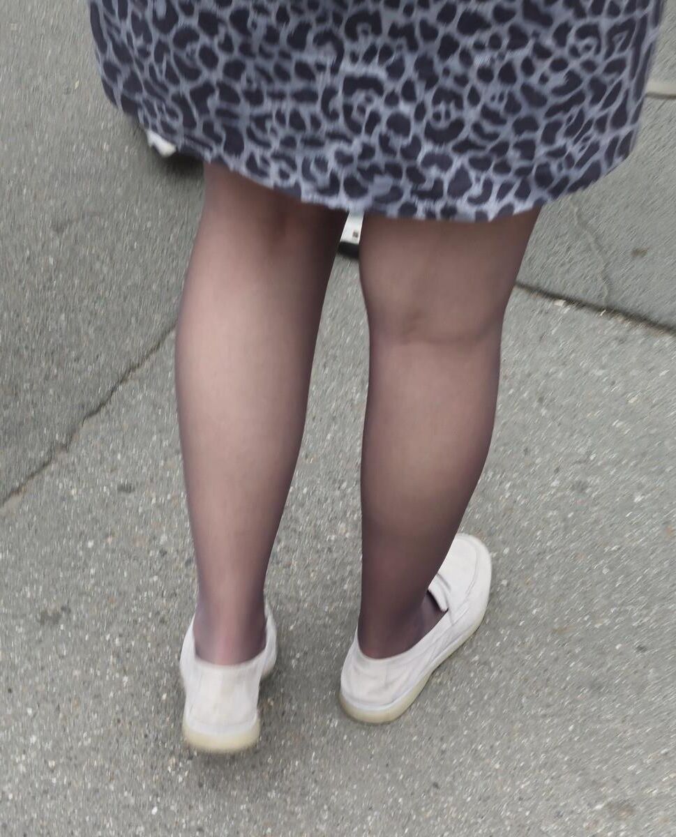 Woman in brown pantyhose and skirt