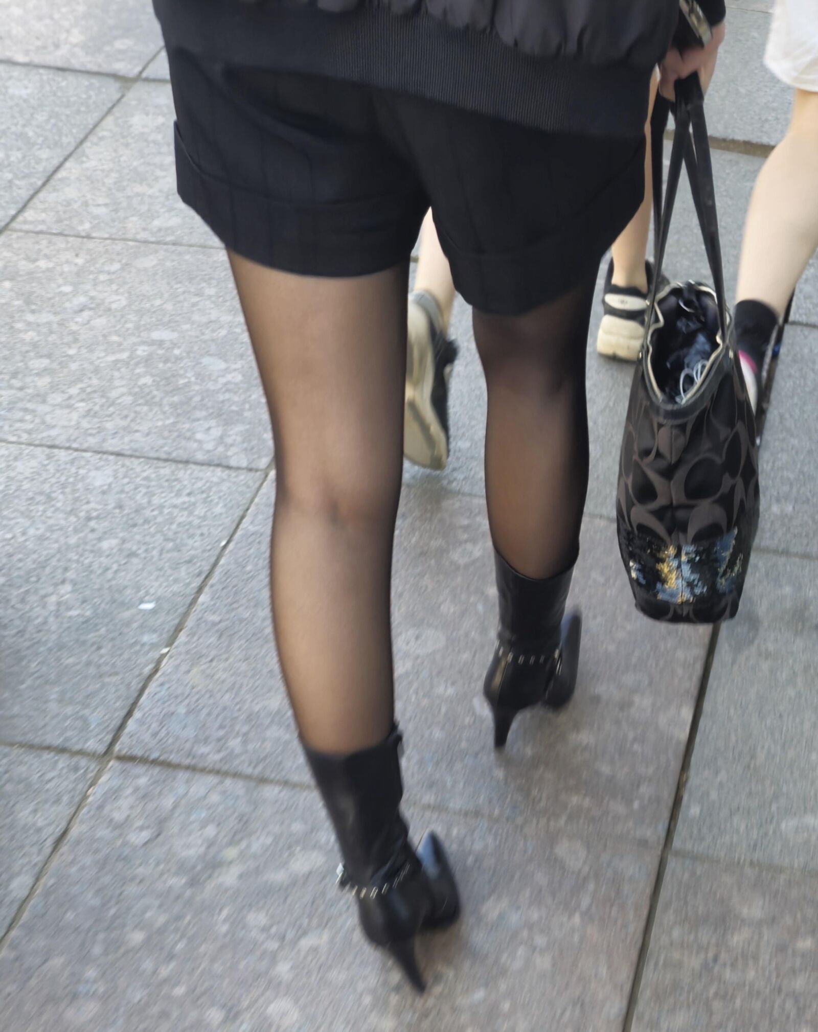 Girl in black pantyhose and leather boots