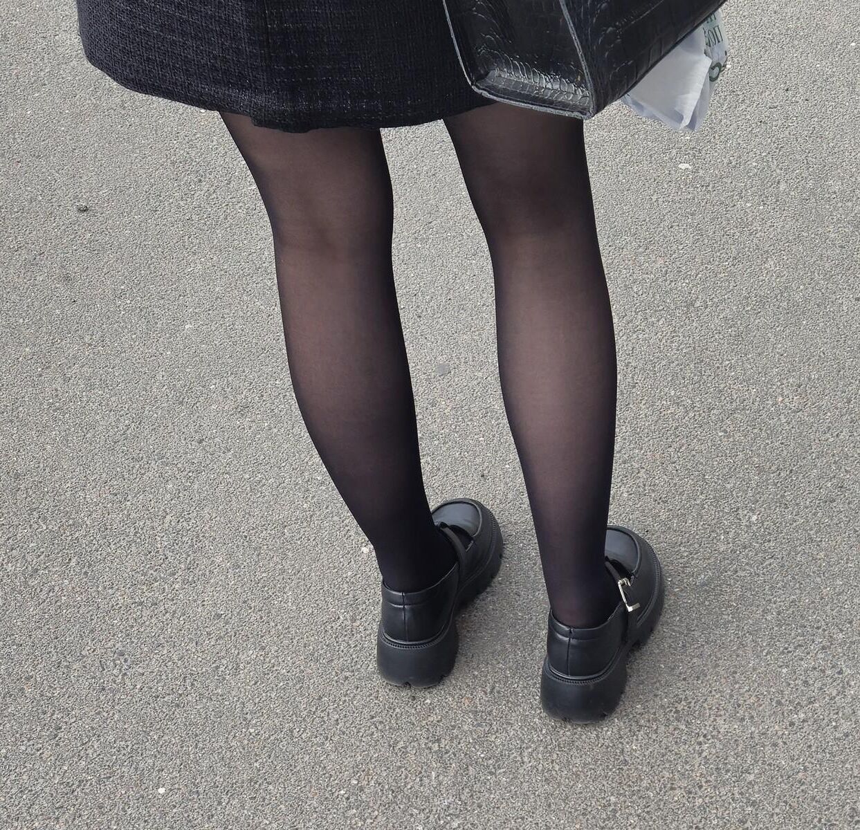 Girl in black pantyhose and mini skirt