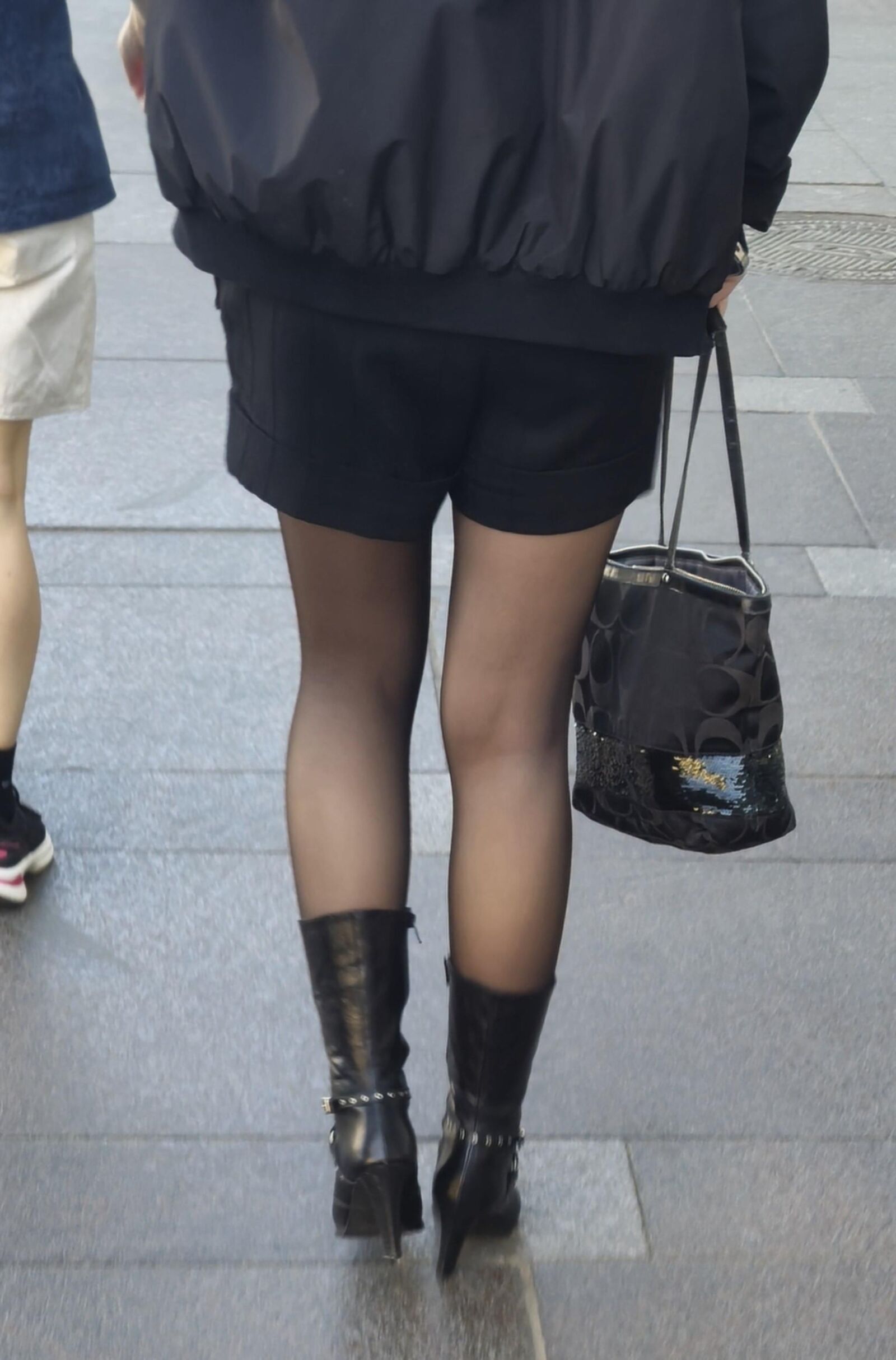 Girl in black pantyhose and leather boots
