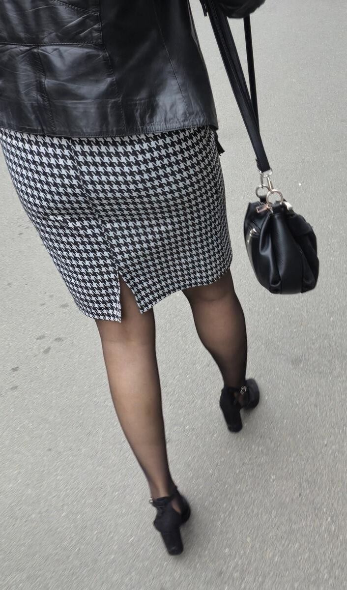 Business woman in midi skirt, pantyhose and suede heels