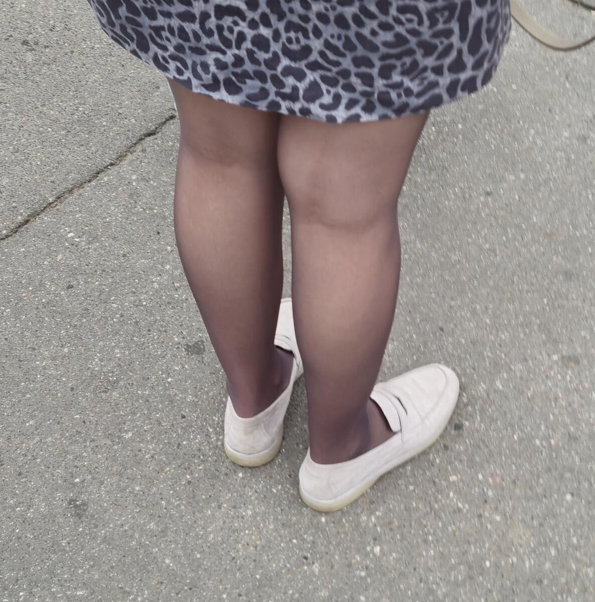 Woman in brown pantyhose and skirt