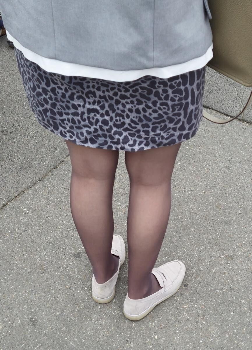 Woman in brown pantyhose and skirt