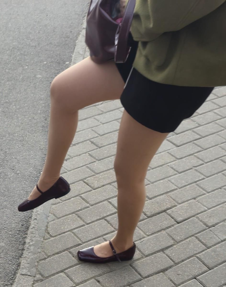 Girl in shorts, nude pantyhose and ballerinas shoes