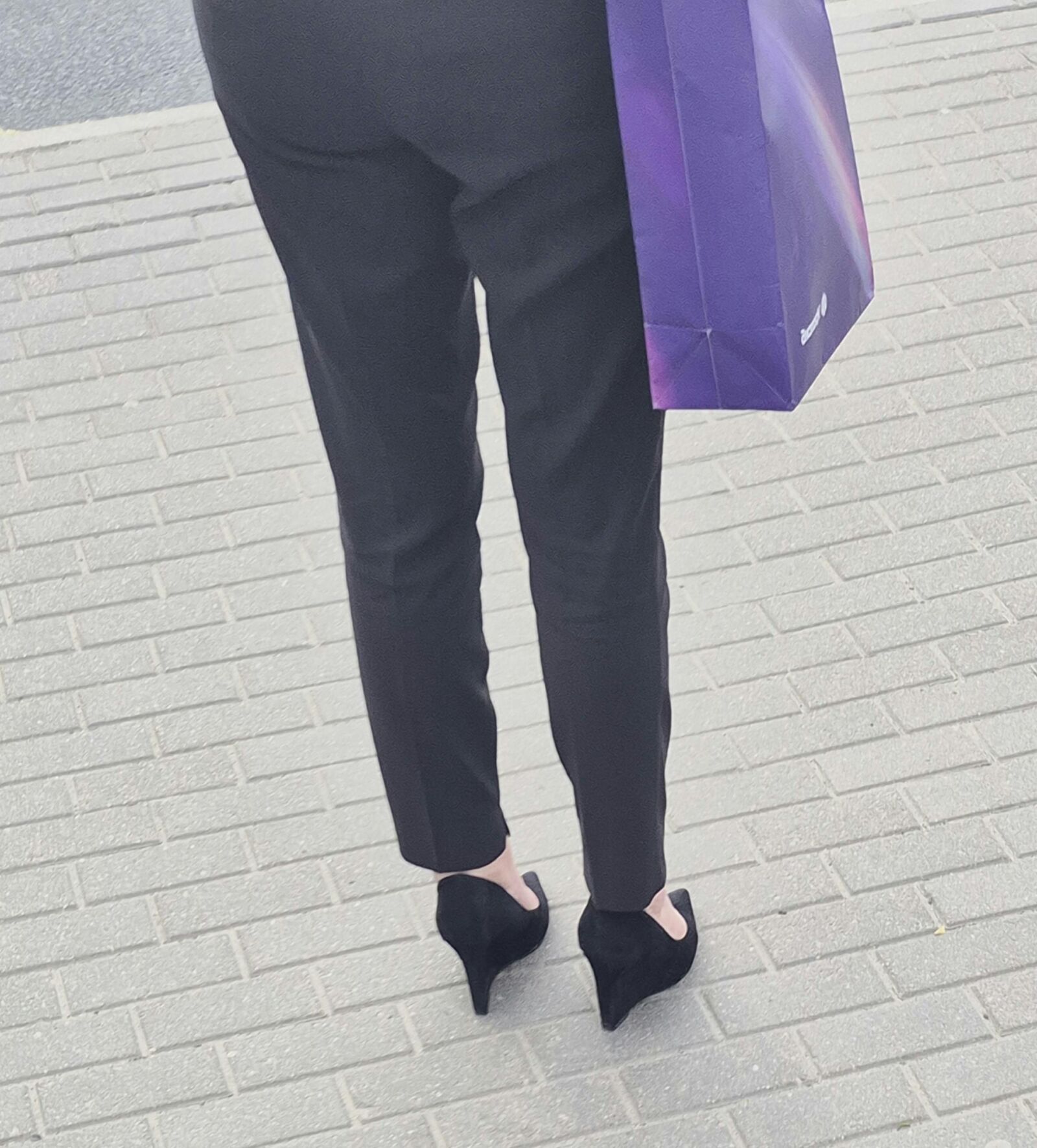 Woman in trousers and suede wedges heels