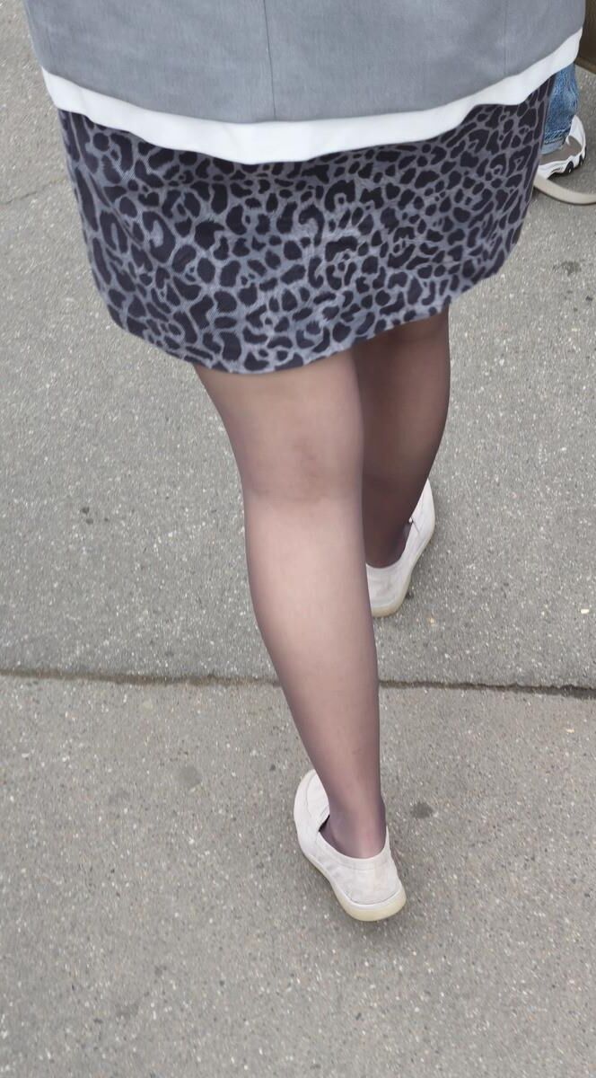 Woman in brown pantyhose and skirt