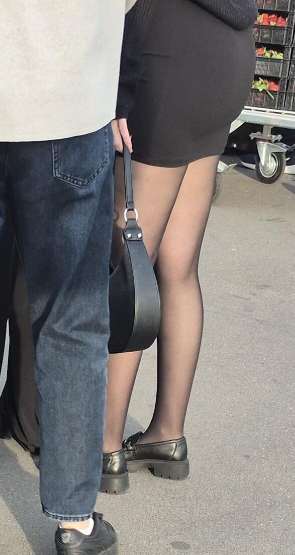 Girl in mini skirt and black pantyhose