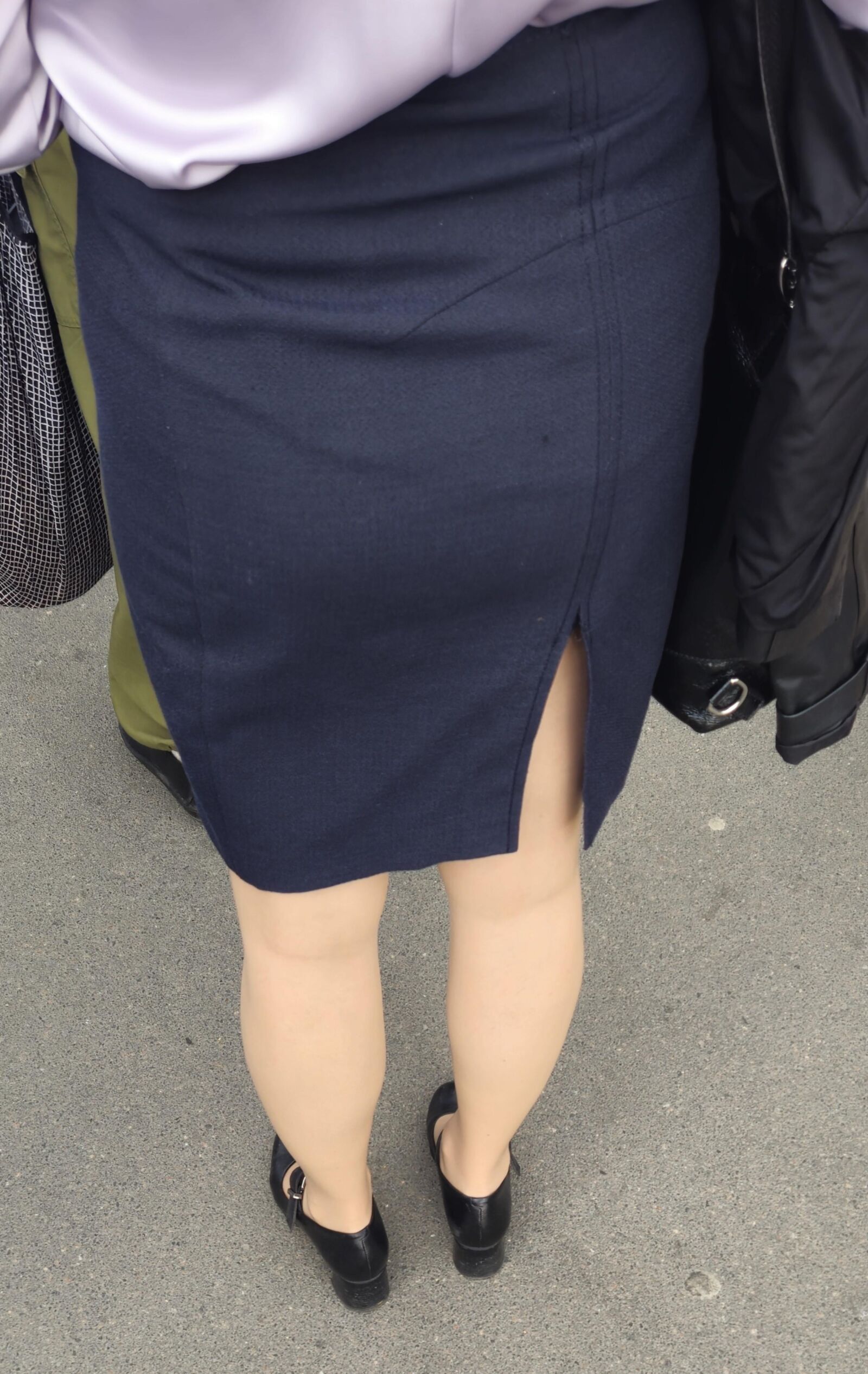 Woman in midi skirt and nude pantyhose