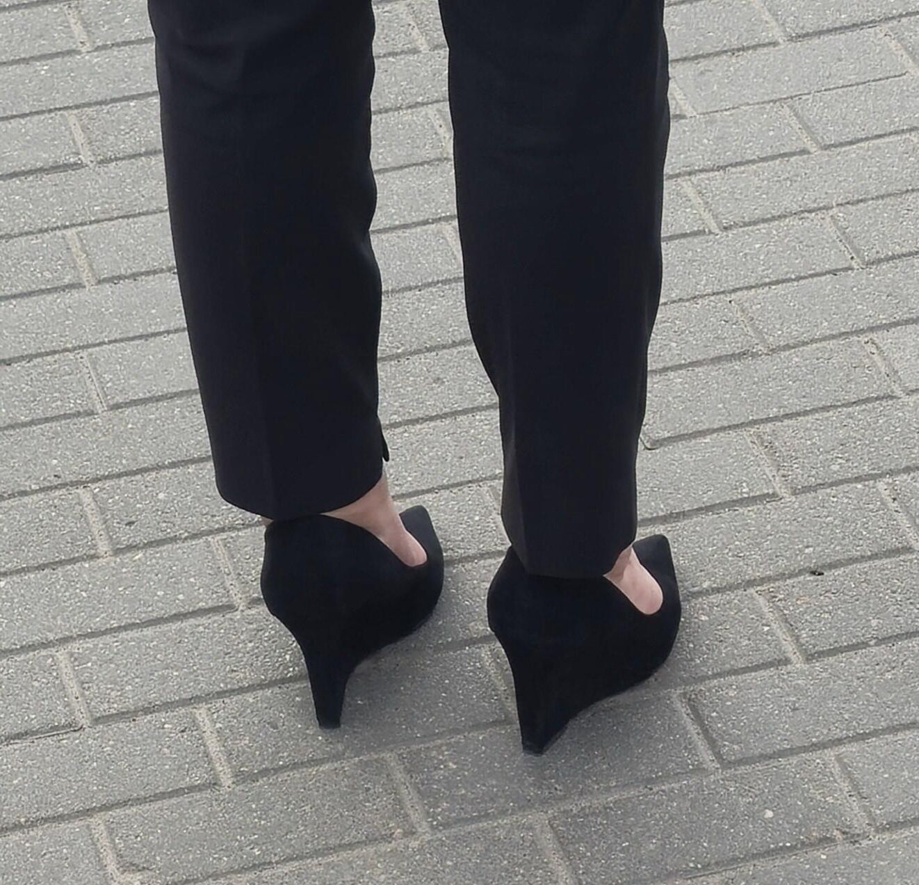 Woman in trousers and suede wedges heels