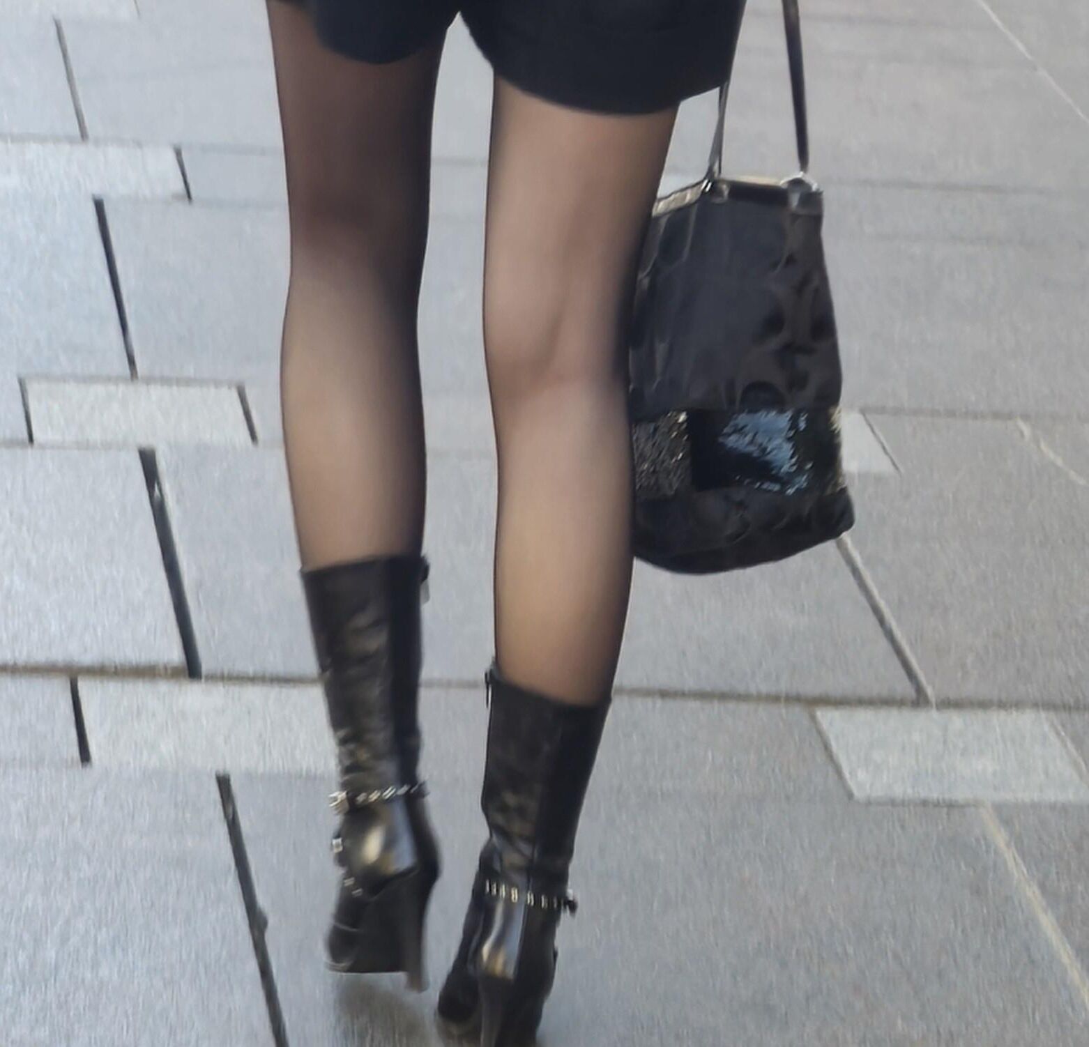 Girl in black pantyhose and leather boots