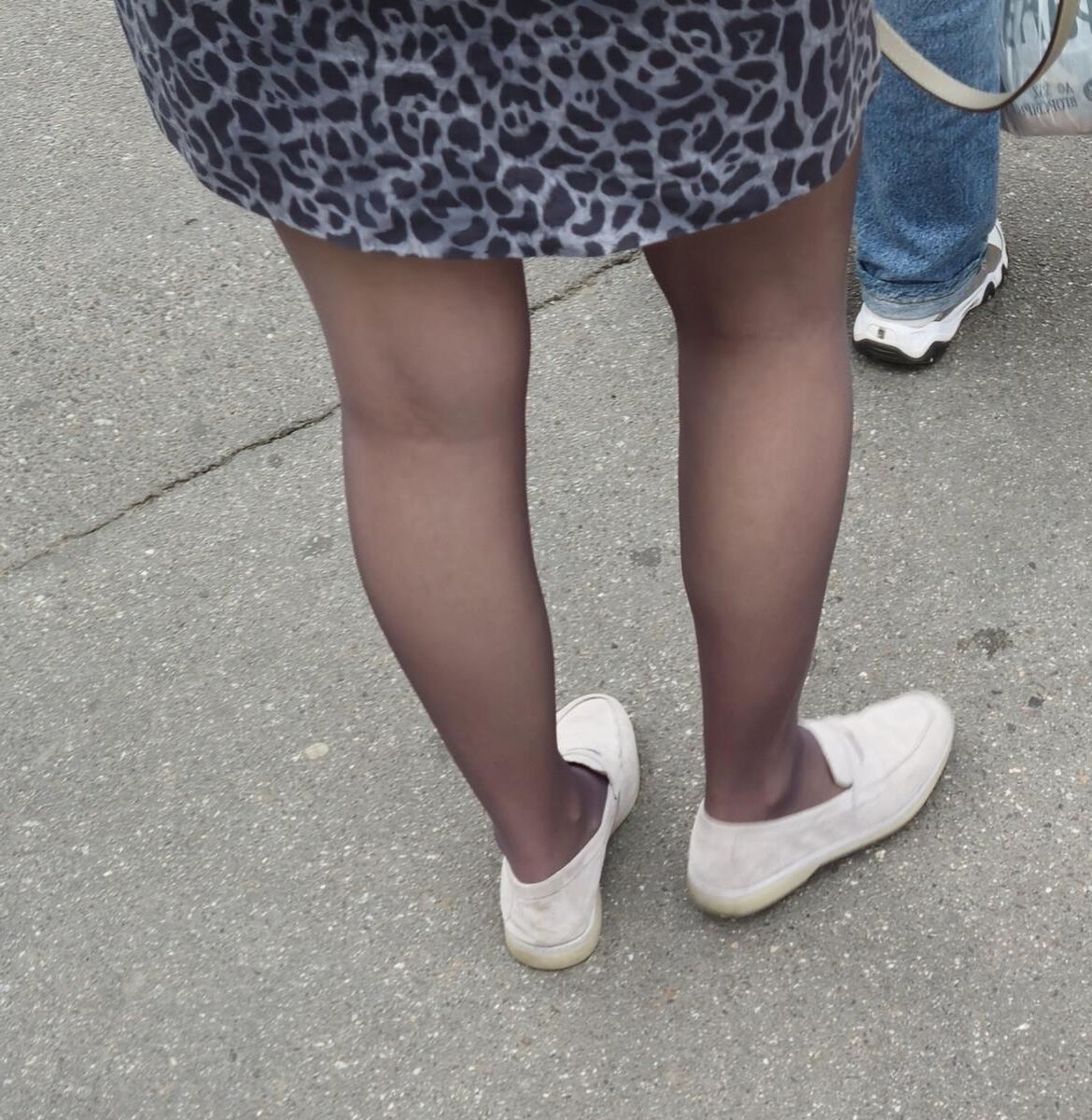 Woman in brown pantyhose and skirt