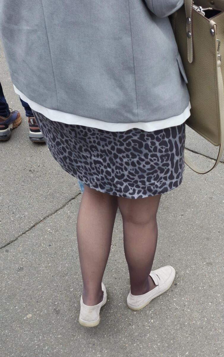Woman in brown pantyhose and skirt