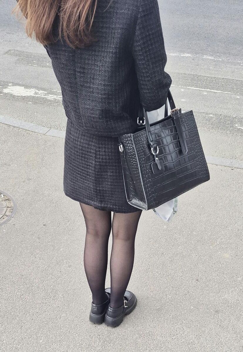 Girl in black pantyhose and mini skirt