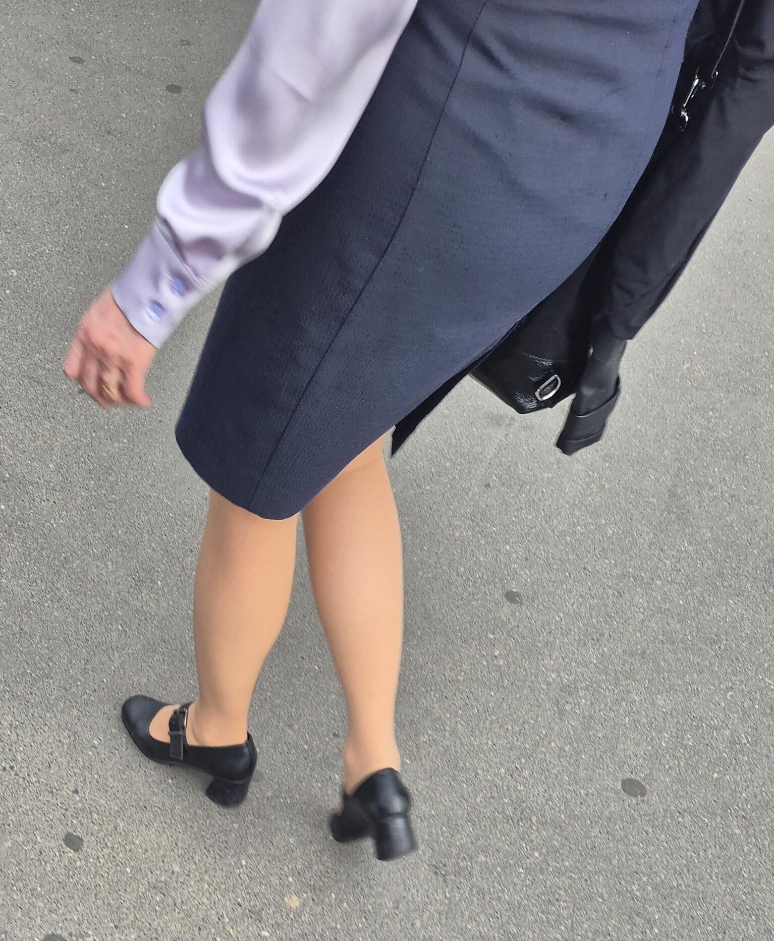 Woman in midi skirt and nude pantyhose
