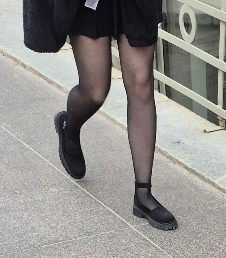 Girl in mini skirt, black pantyhose and suede sandals
