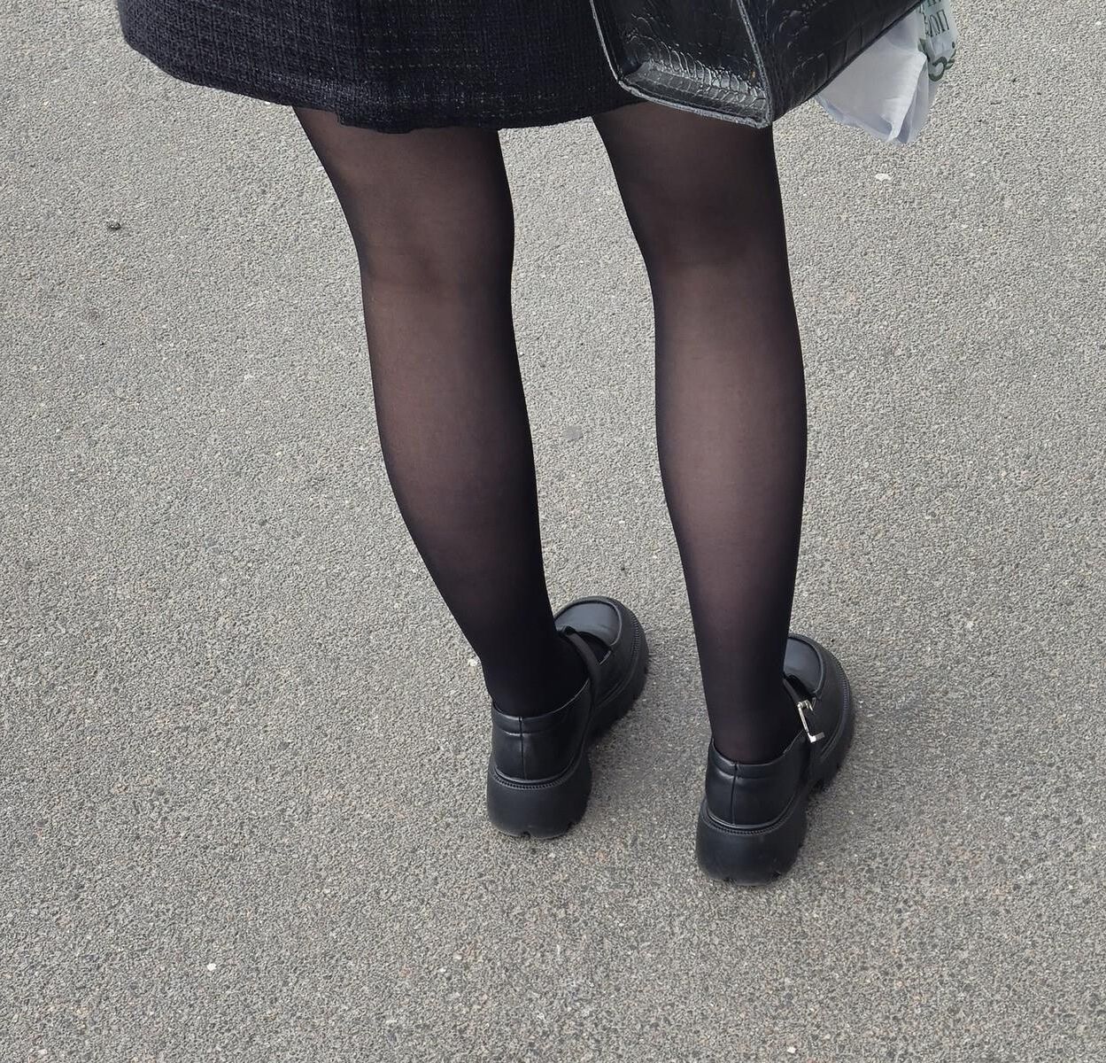 Girl in black pantyhose and mini skirt