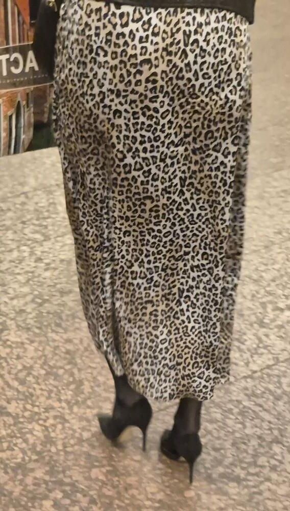 Woman in long leopard print skirt