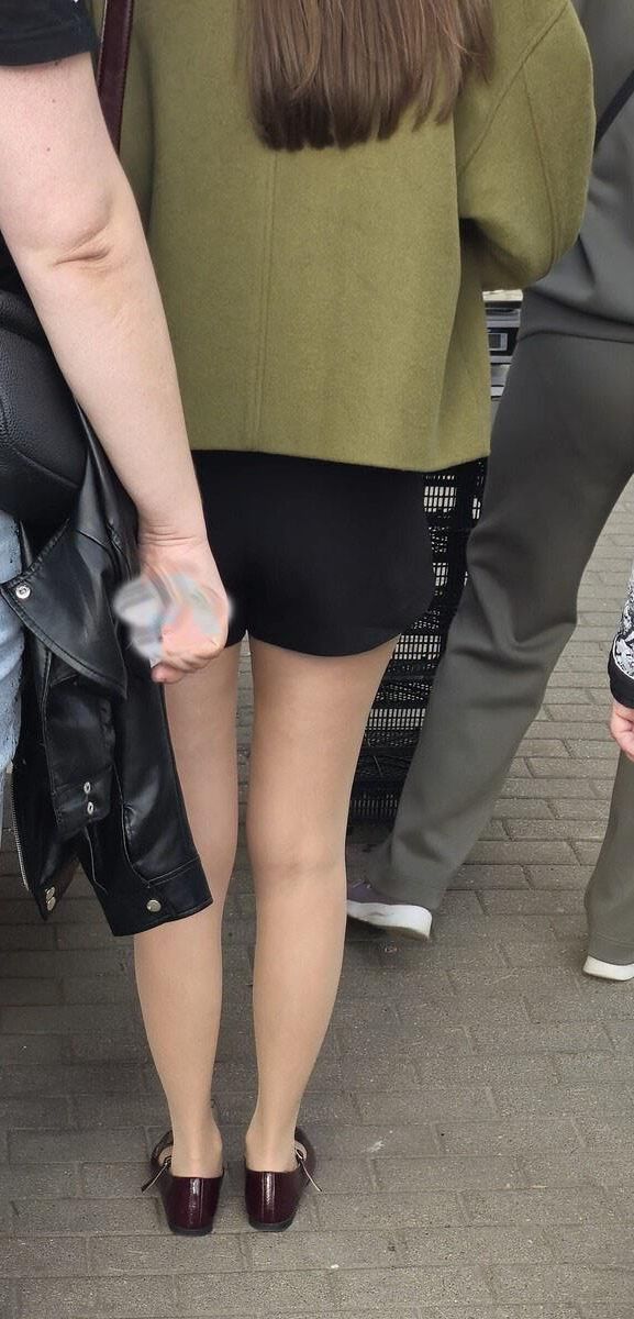 Girl in shorts, nude pantyhose and ballerinas shoes