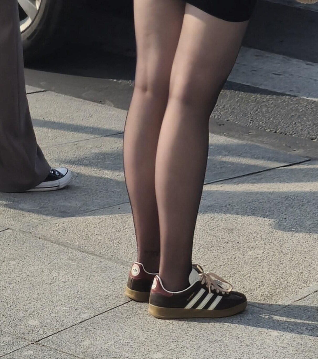 黒いタイツの女の子、ミニスカート、スニーカー
