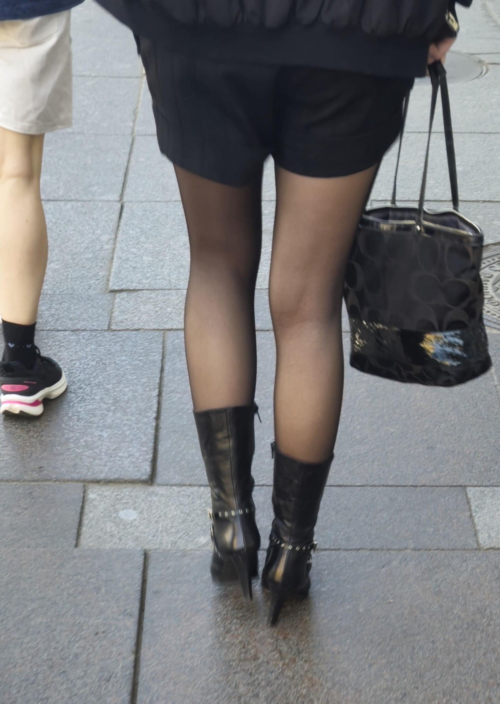 Girl in black pantyhose and leather boots