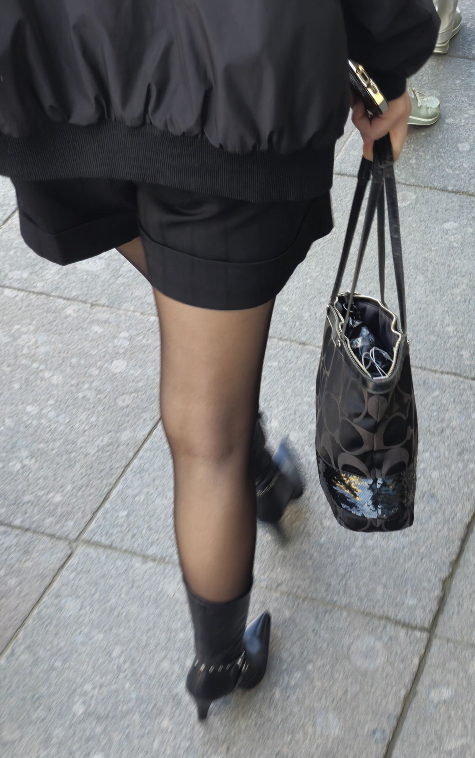 Girl in black pantyhose and leather boots