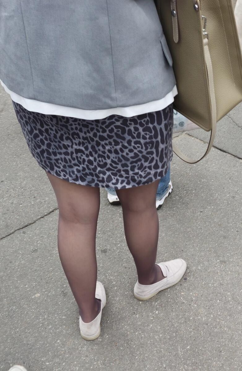 Woman in brown pantyhose and skirt