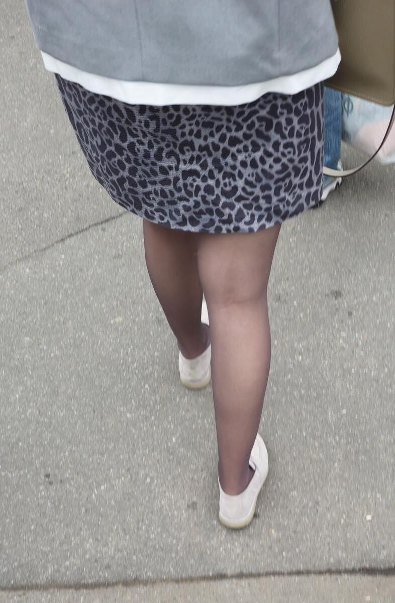 Woman in brown pantyhose and skirt