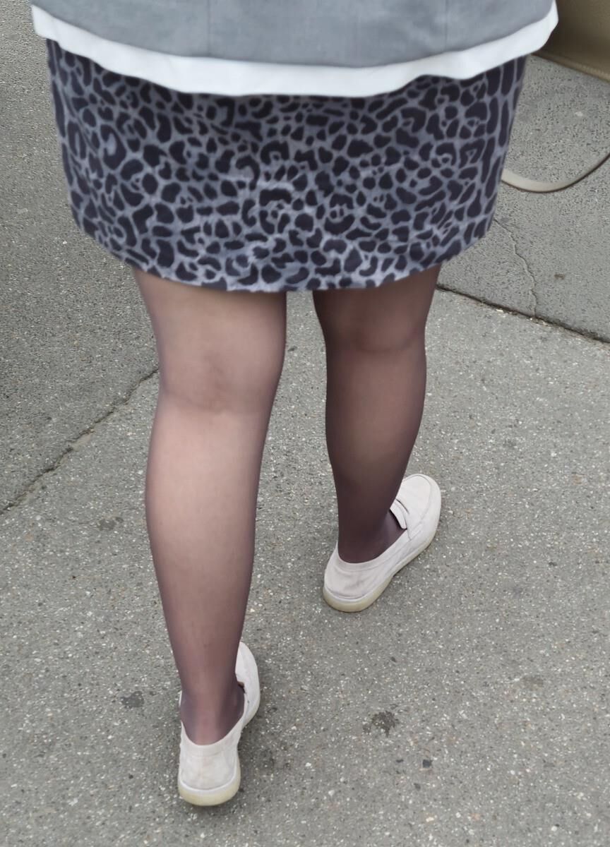 Woman in brown pantyhose and skirt