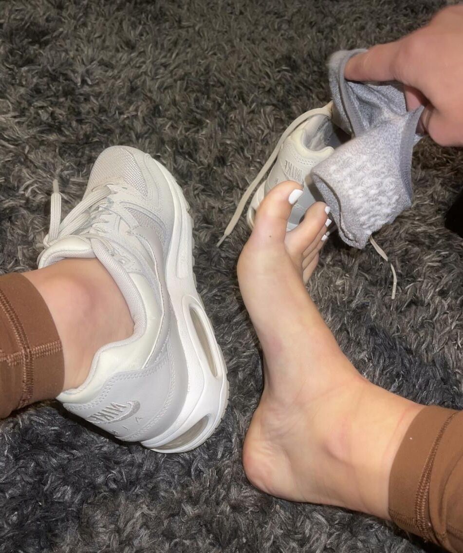 Kristin removing her sweaty shoes