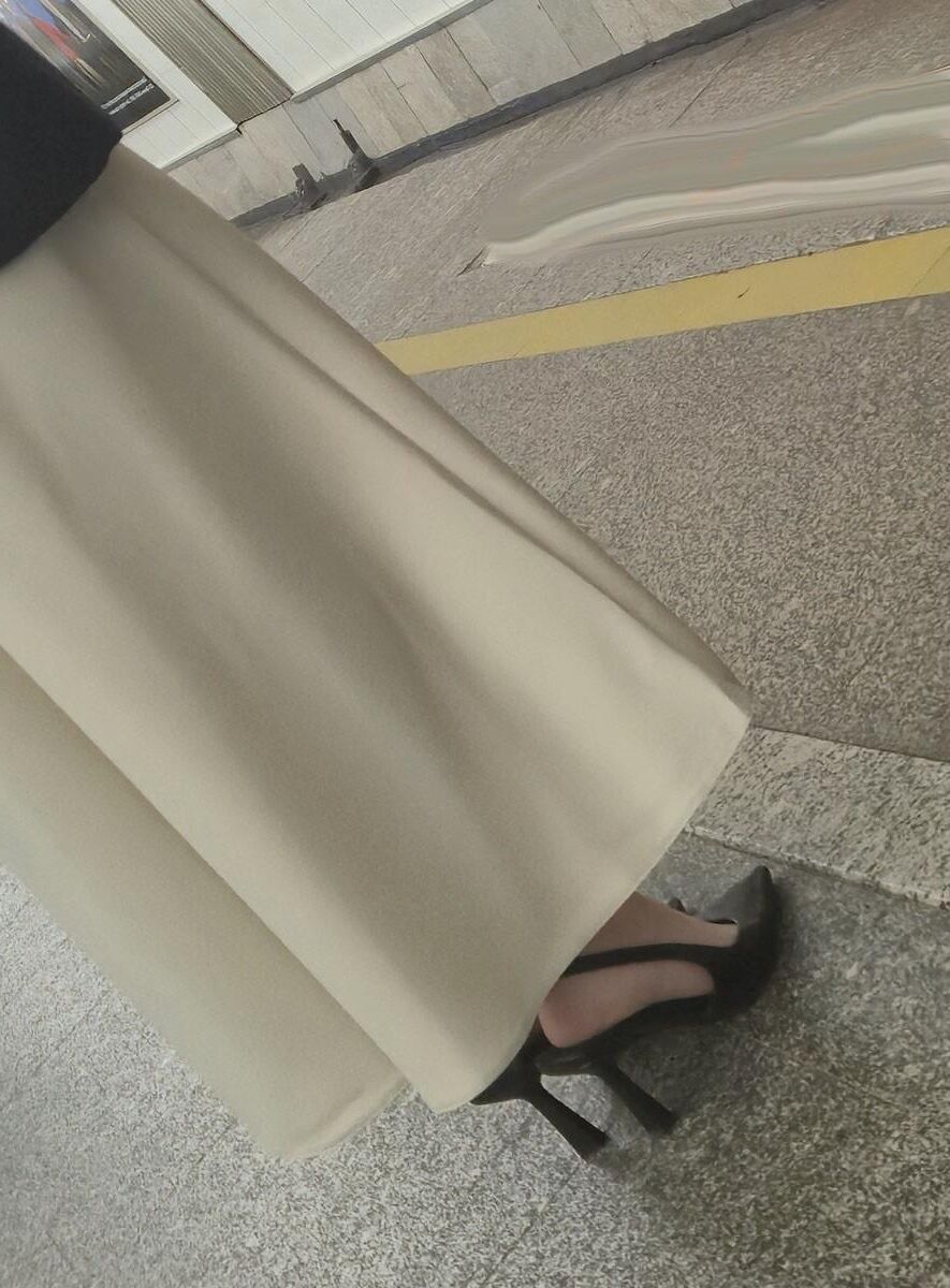 長いサテンのドレス、かかと、ジャケットを着た女の子