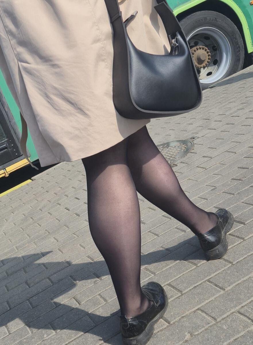 マントとブラックパンストの女性