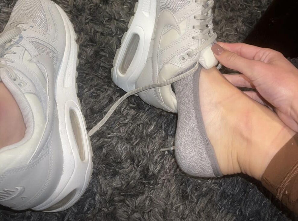 Kristin removing her sweaty shoes
