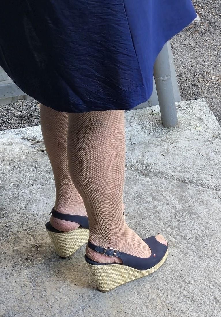 Co worker in fishnet pantyhose and wedges heels