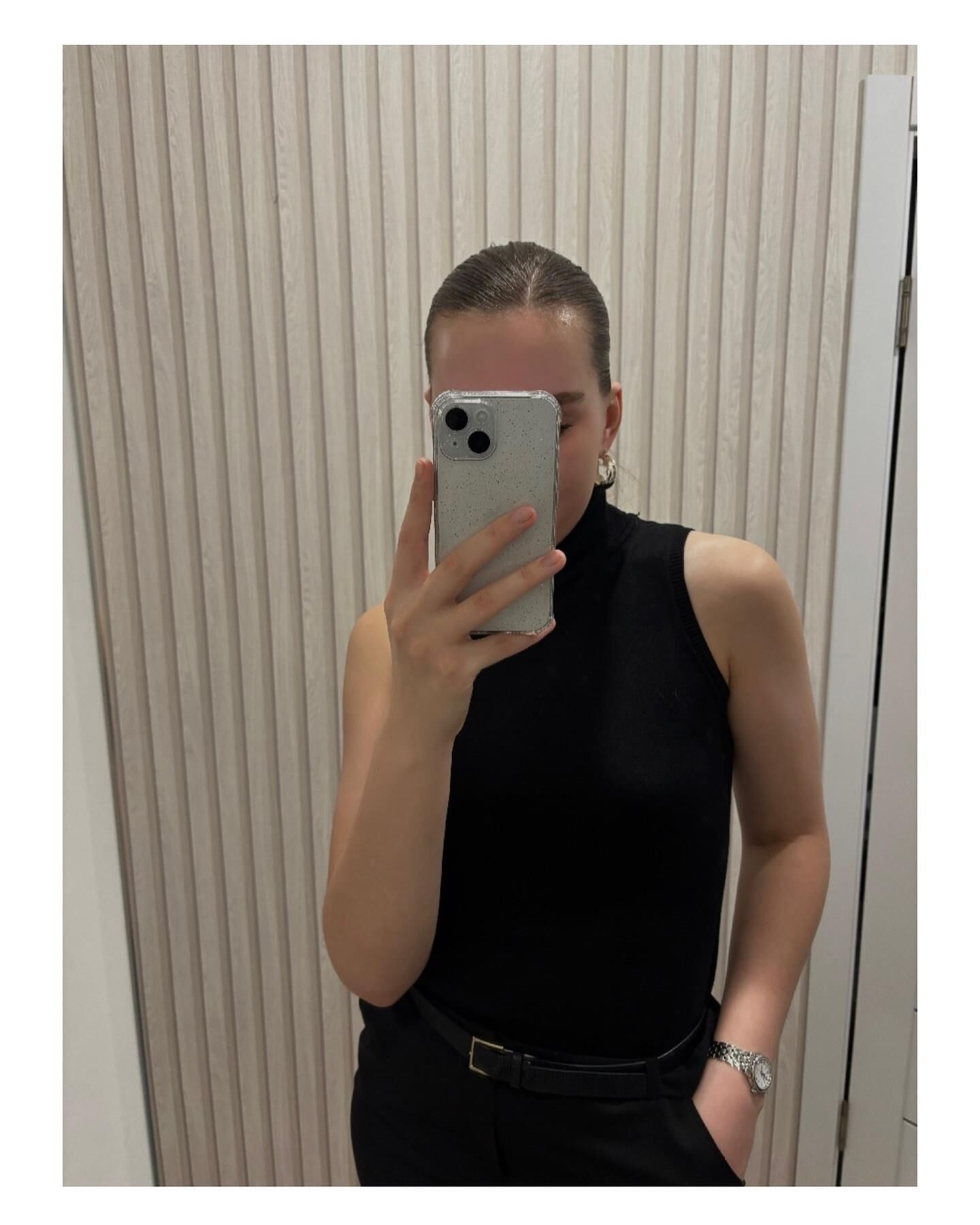 Black sleeveless tops and metal wristwatches #