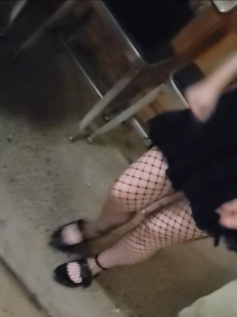 Candid skinny goth girl in fishnets on the street at night