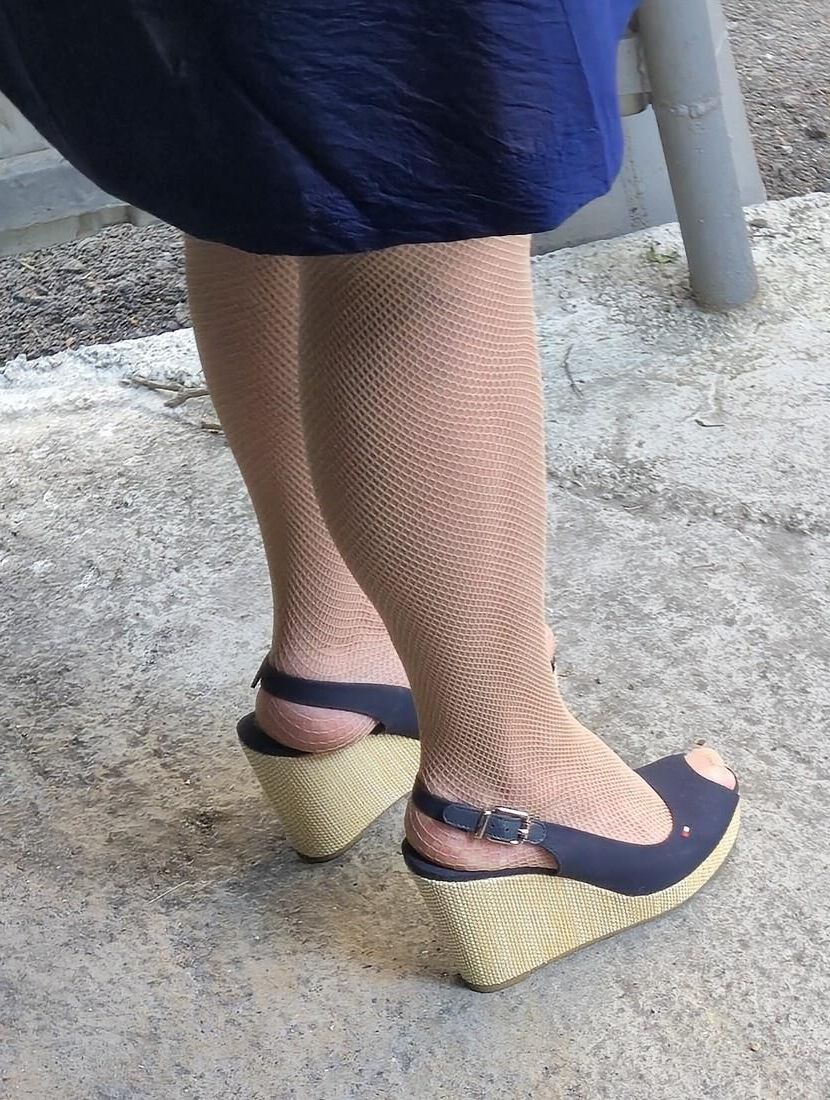 Co worker in fishnet pantyhose and wedges heels