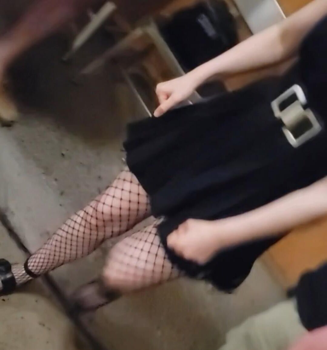 Candid skinny goth girl in fishnets on the street at night