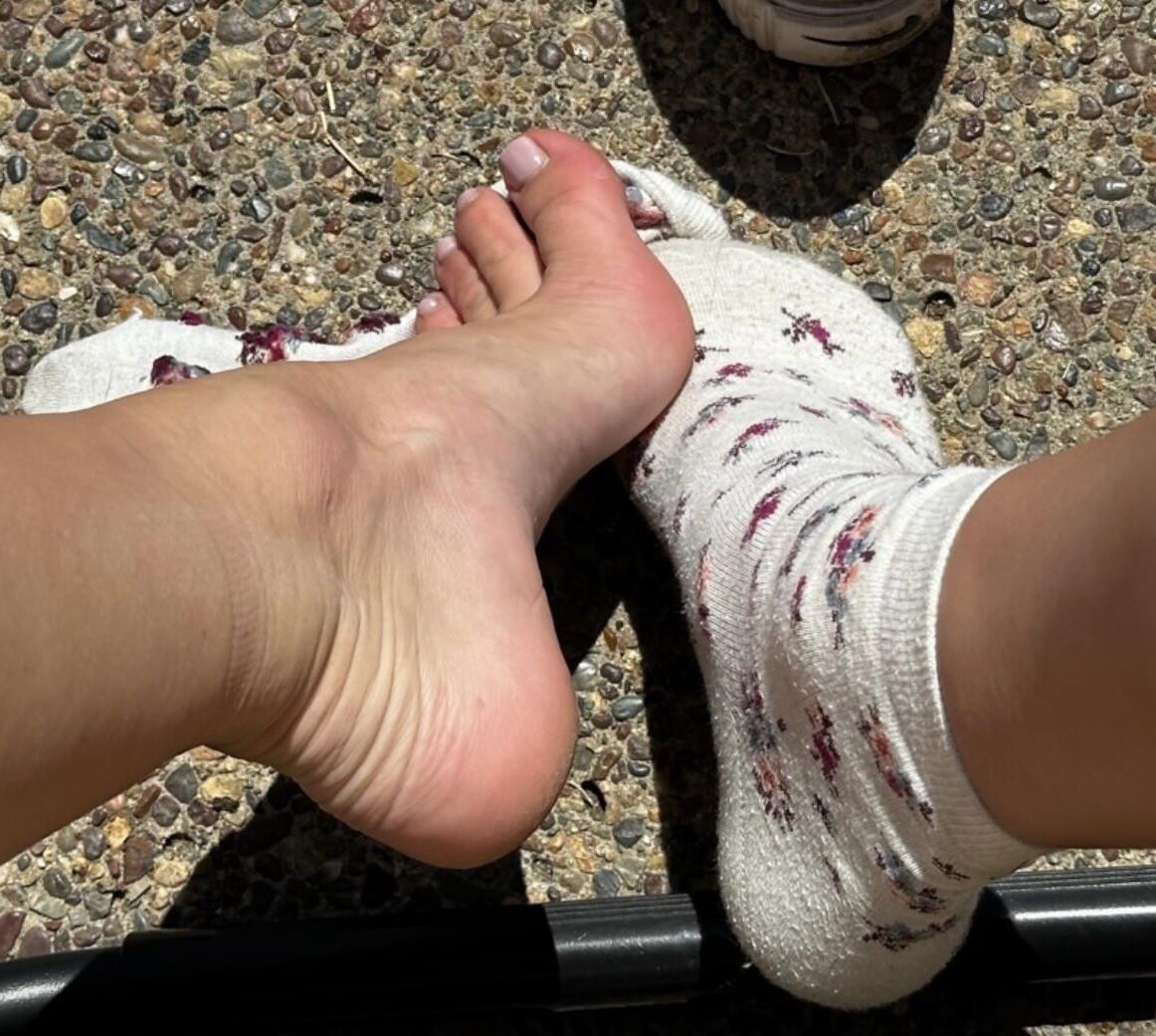 Kristin removes shoes and her sweaty, dirty socks