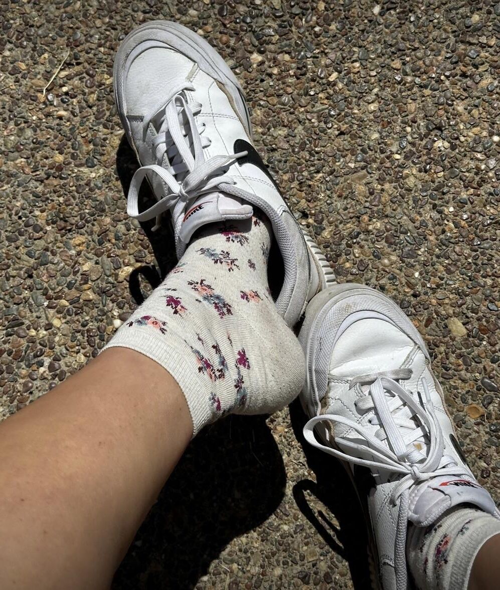 Kristin removes shoes and her sweaty, dirty socks