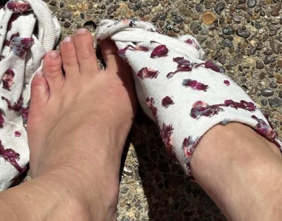 Kristin removes shoes and her sweaty, dirty socks