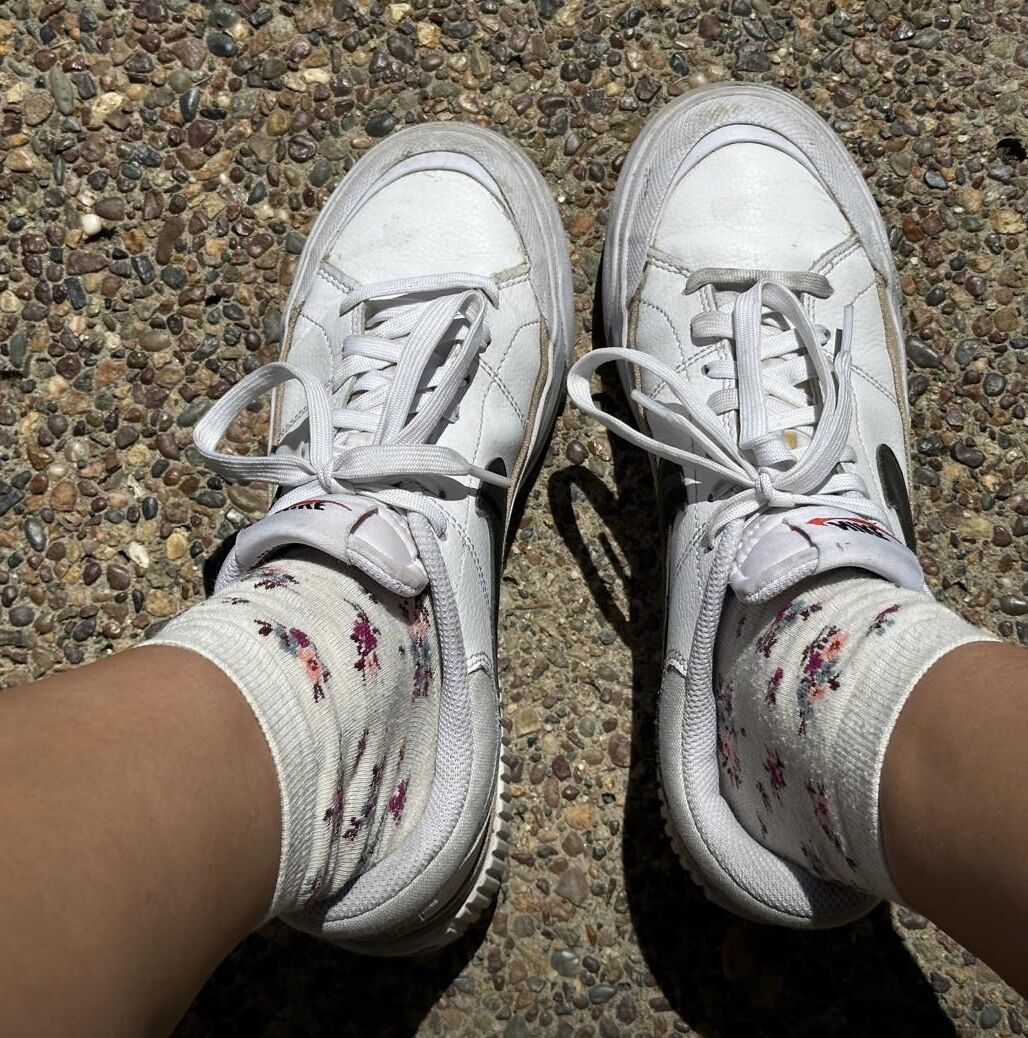 Kristin removes shoes and her sweaty, dirty socks