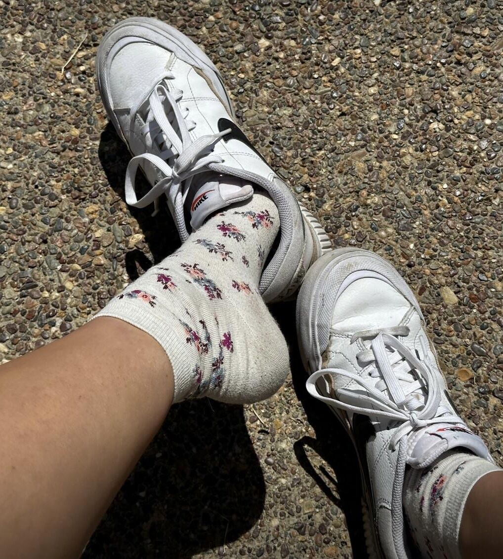 Kristin removes shoes and her sweaty, dirty socks