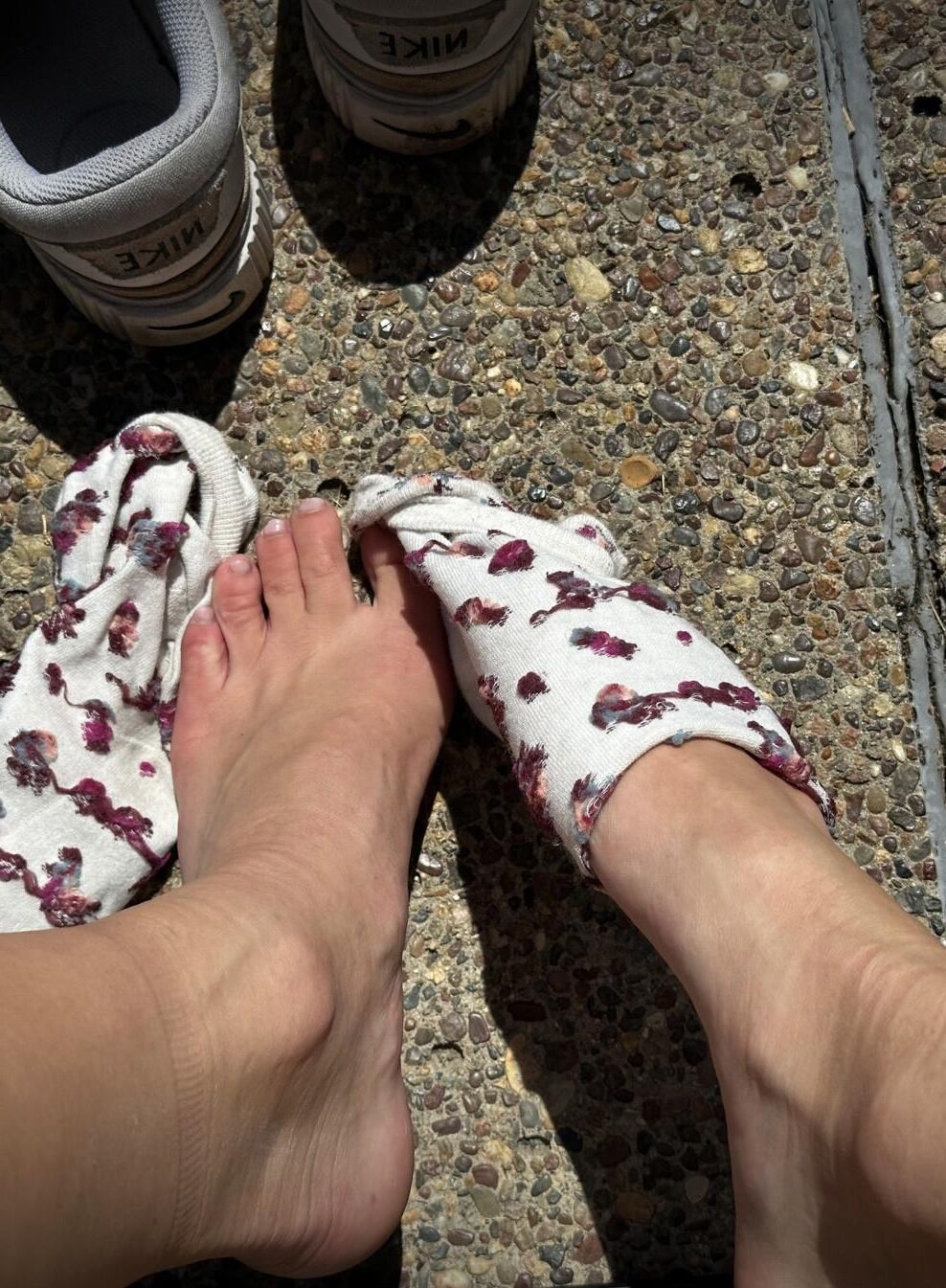 Kristin removes shoes and her sweaty, dirty socks