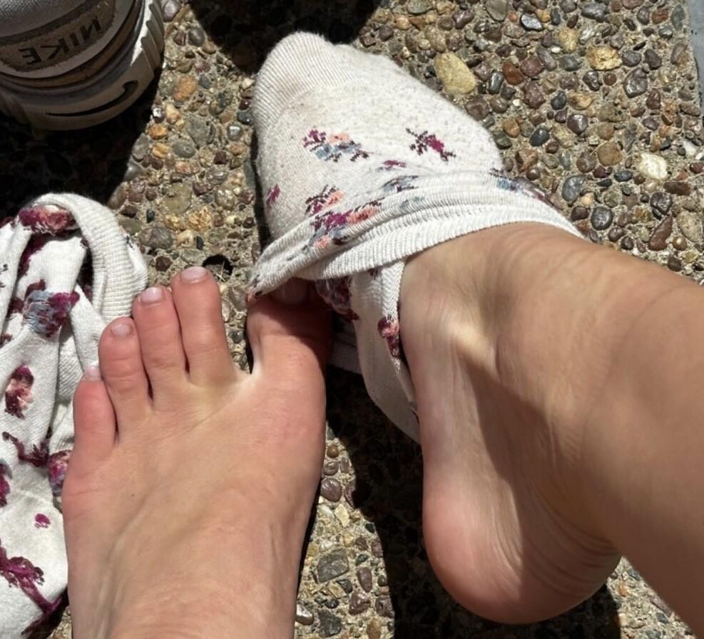 Kristin removes shoes and her sweaty, dirty socks
