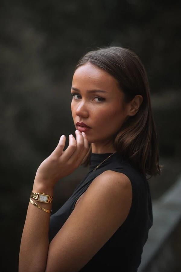Black sleeveless tops and metal wristwatches #
