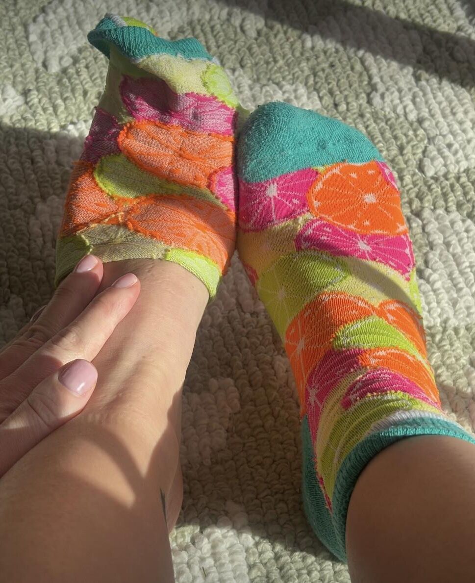 Ash removing socks to show her blue toes and hot soles