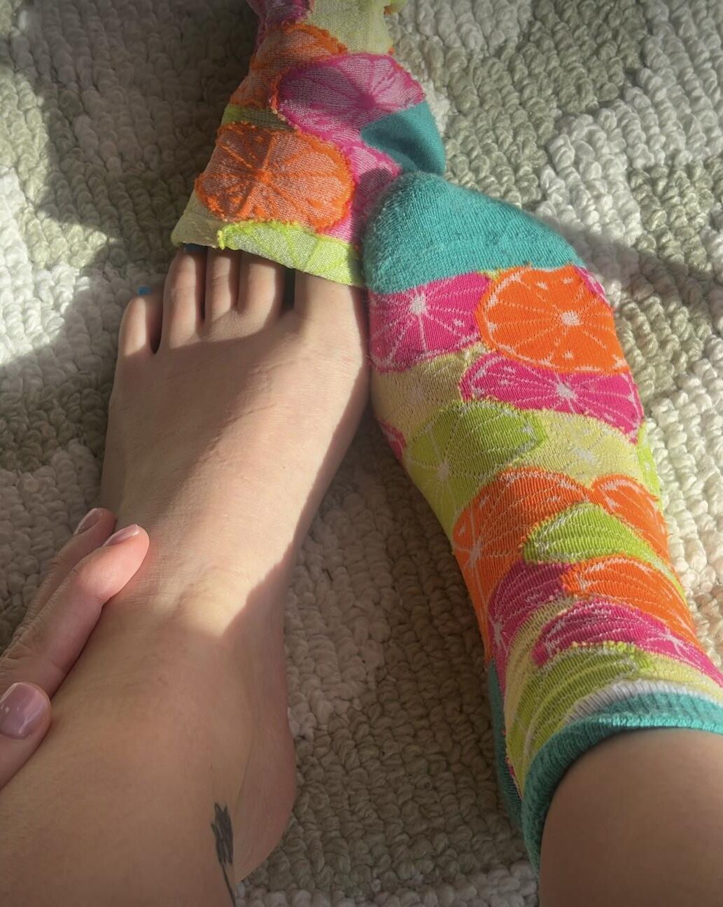 Ash removing socks to show her blue toes and hot soles