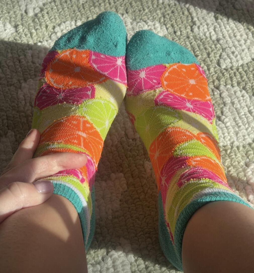 Ash removing socks to show her blue toes and hot soles